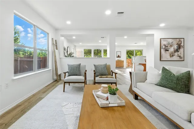 a dining room with furniture and a wooden floor