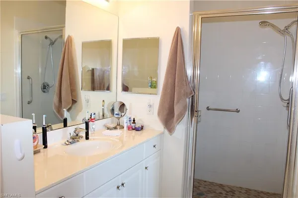 a bathroom with a sink vanity and a mirror