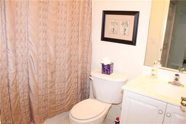 a white toilet sitting next to a bathroom sink