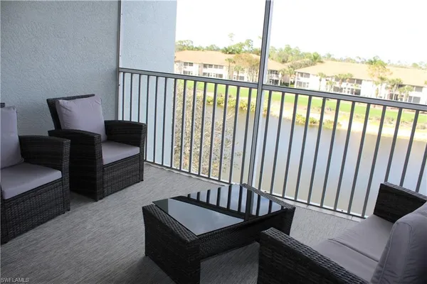 a living room with furniture and a floor to ceiling window