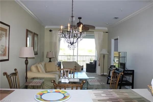 a living room with furniture a window and a chandelier