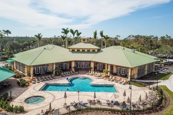 a aerial view of a house with swimming pool and a yard