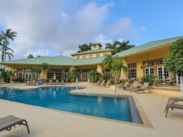 an outdoor space with swimming pool and furniture