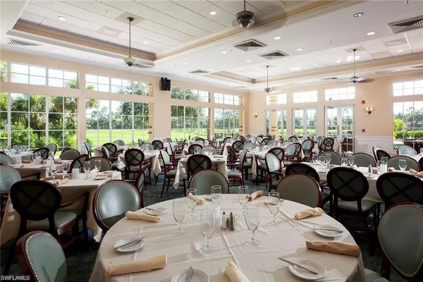 a large room with lots of white furniture