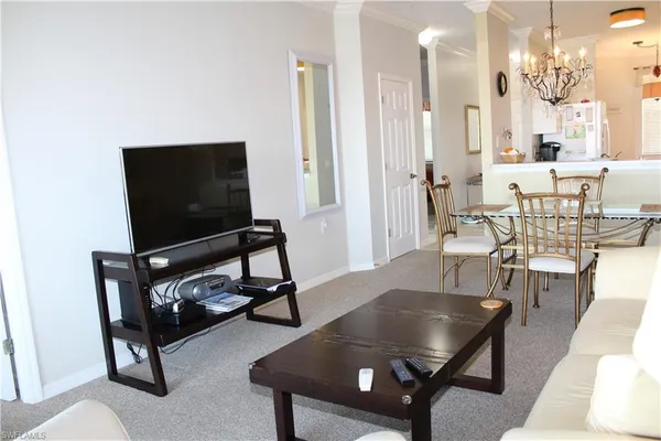 a living room with furniture a rug and a flat screen tv