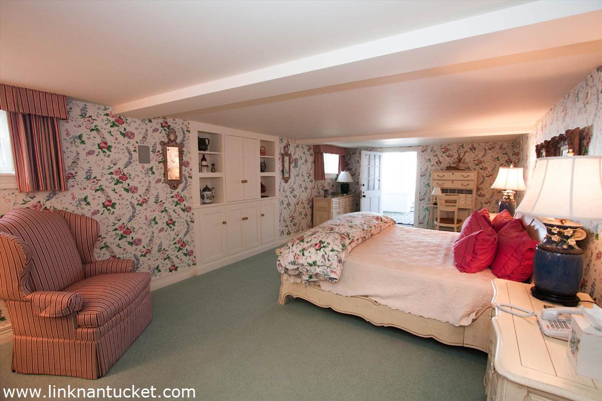 27 Cliff Road Nantucket, MA 02554 - Photo 25 of 32 a bedroom with a bed couch and window