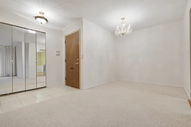 a view of an empty room with a chandelier