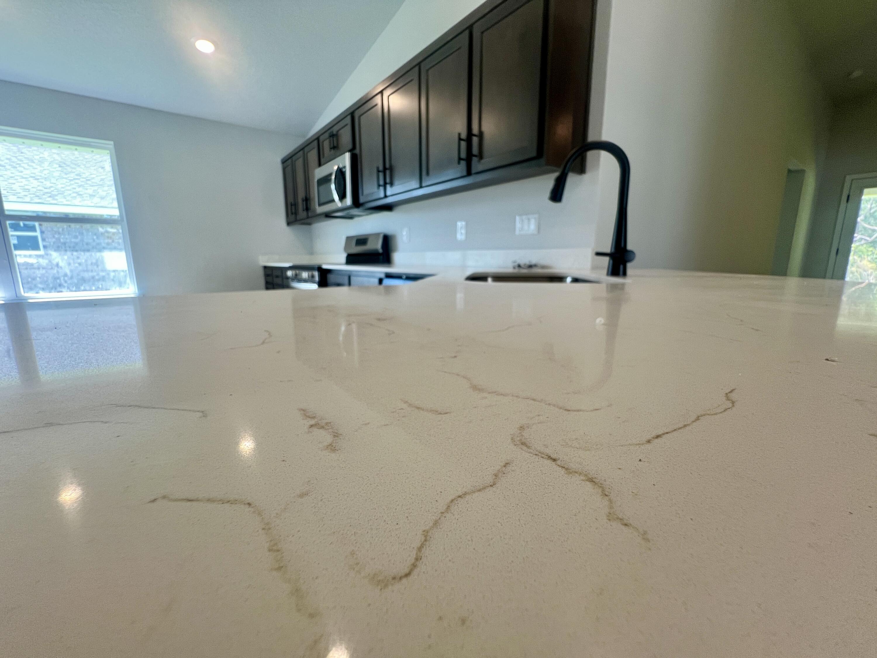 5283 Hidden Pines Circle Milton, FL 32583 - Photo 11 of 16 a kitchen with stainless steel appliances granite countertop a sink a stove and cabinets