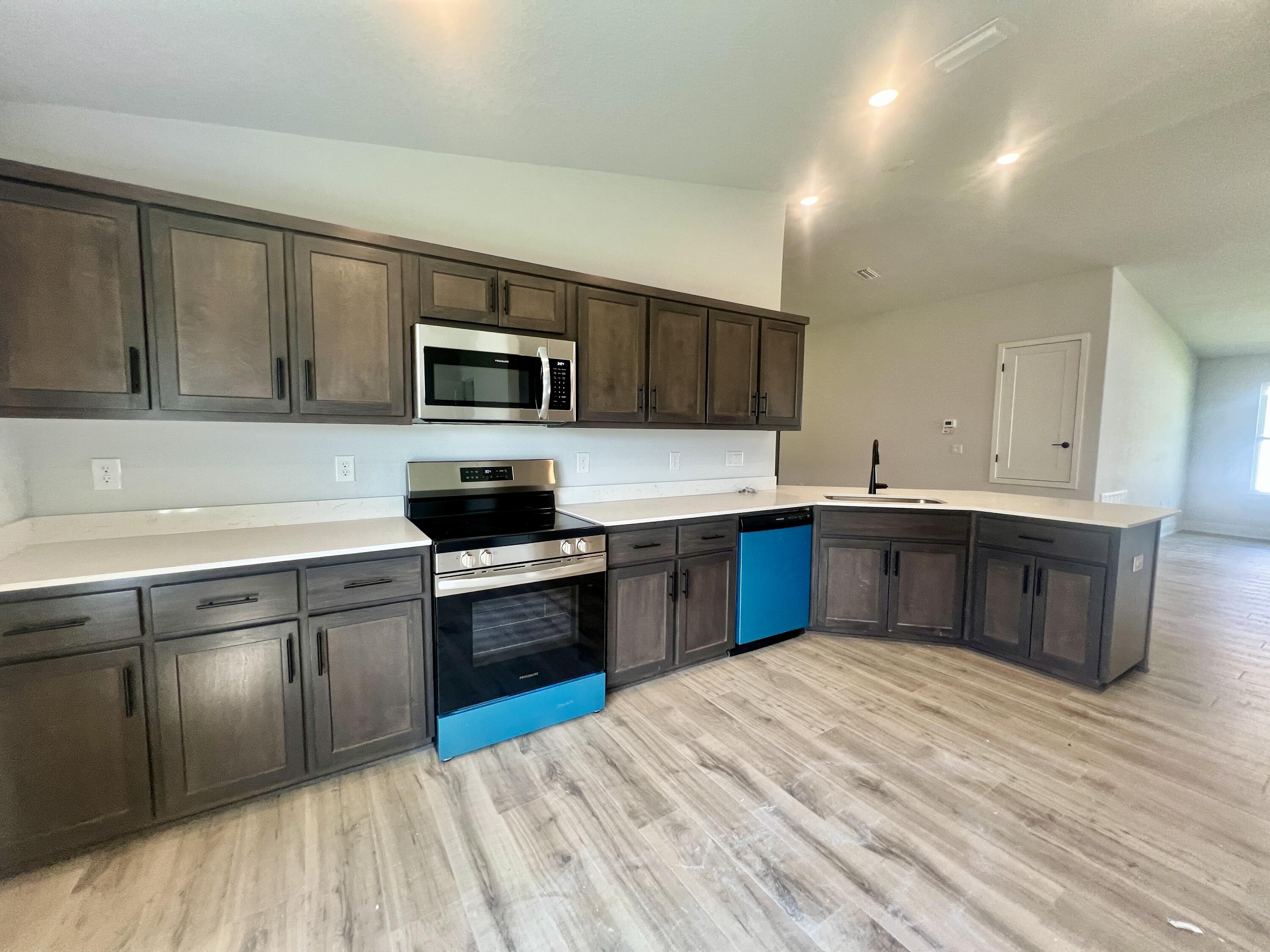5283 Hidden Pines Circle Milton, FL 32583 - Photo 12 of 16 a kitchen with a refrigerator stove top oven and sink