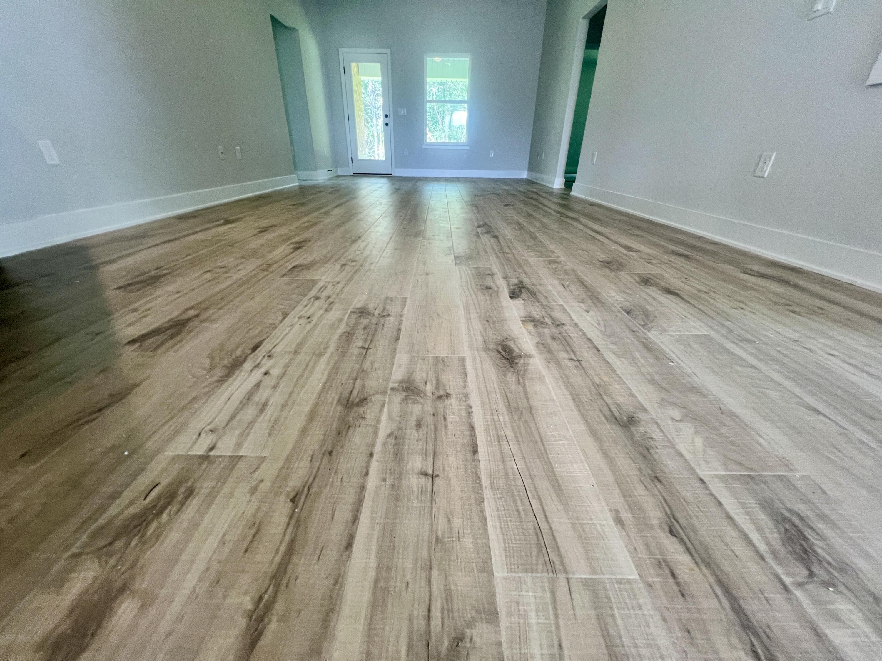 5283 Hidden Pines Circle Milton, FL 32583 - Photo 13 of 16 a view of empty room with wooden floor and fan