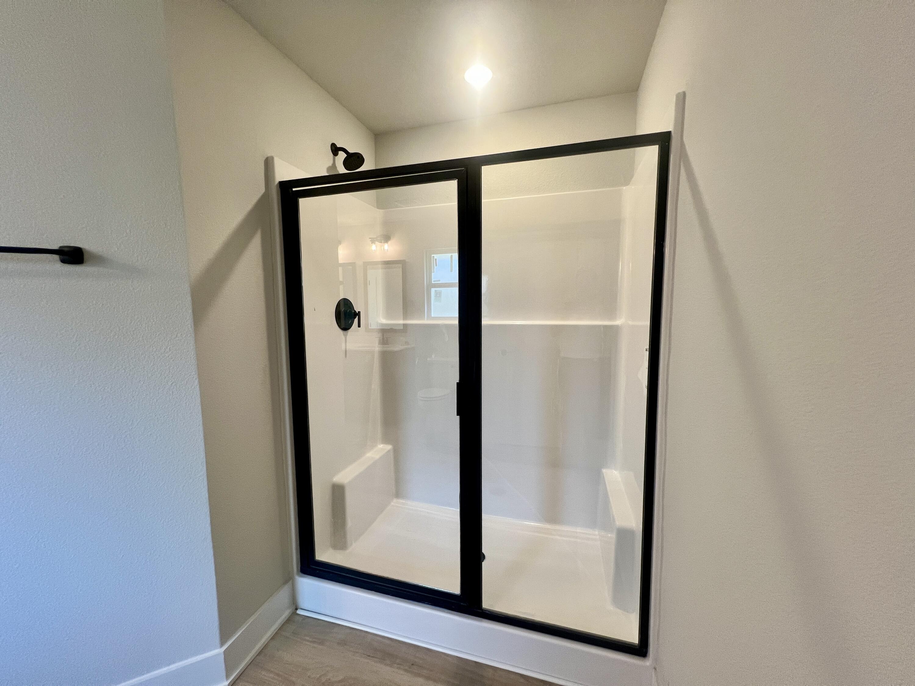 5283 Hidden Pines Circle Milton, FL 32583 - Photo 4 of 16 a bathroom with a glass shower door