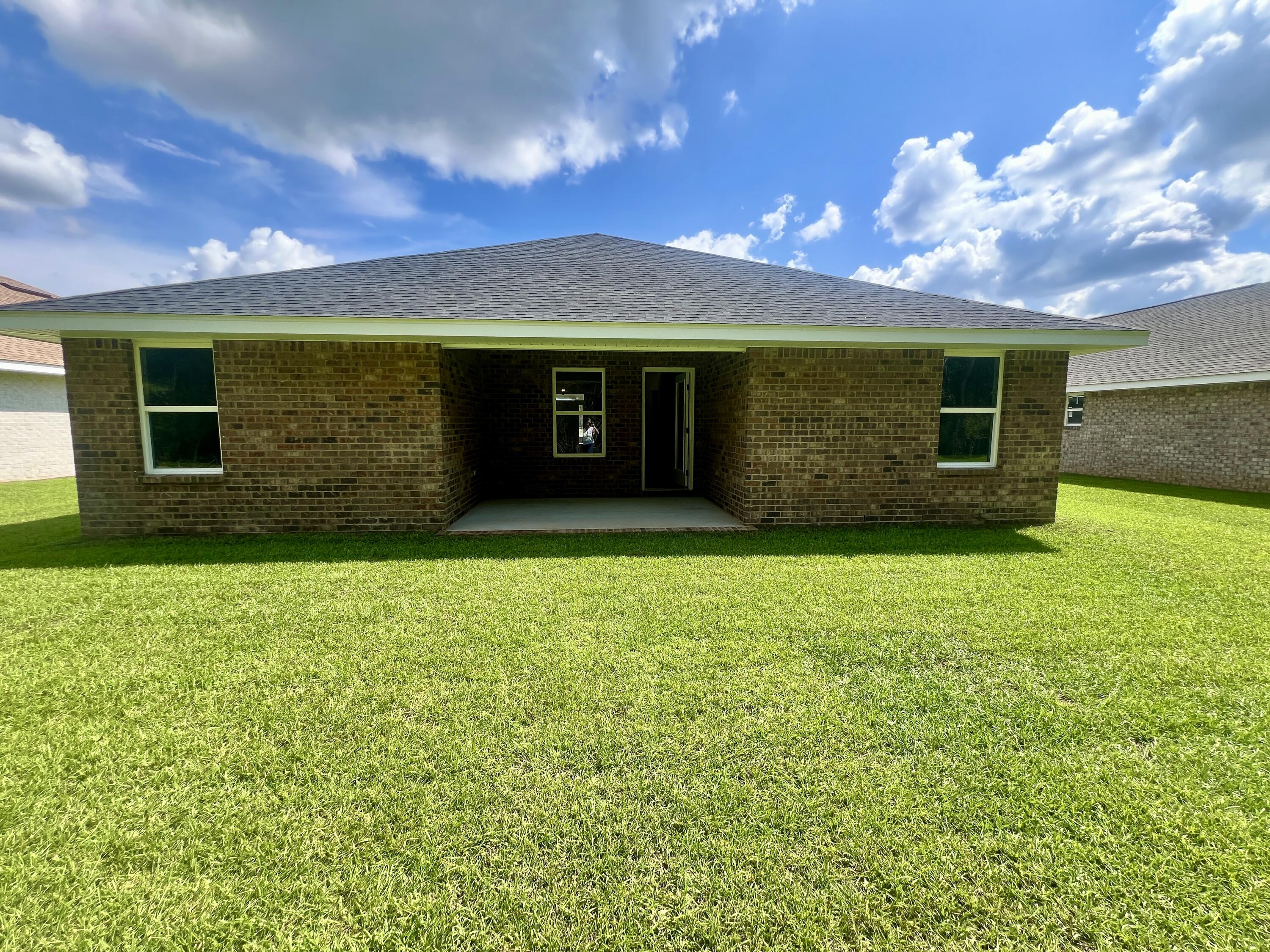 5283 Hidden Pines Circle Milton, FL 32583 - Photo 8 of 16 a view of a house with a garden
