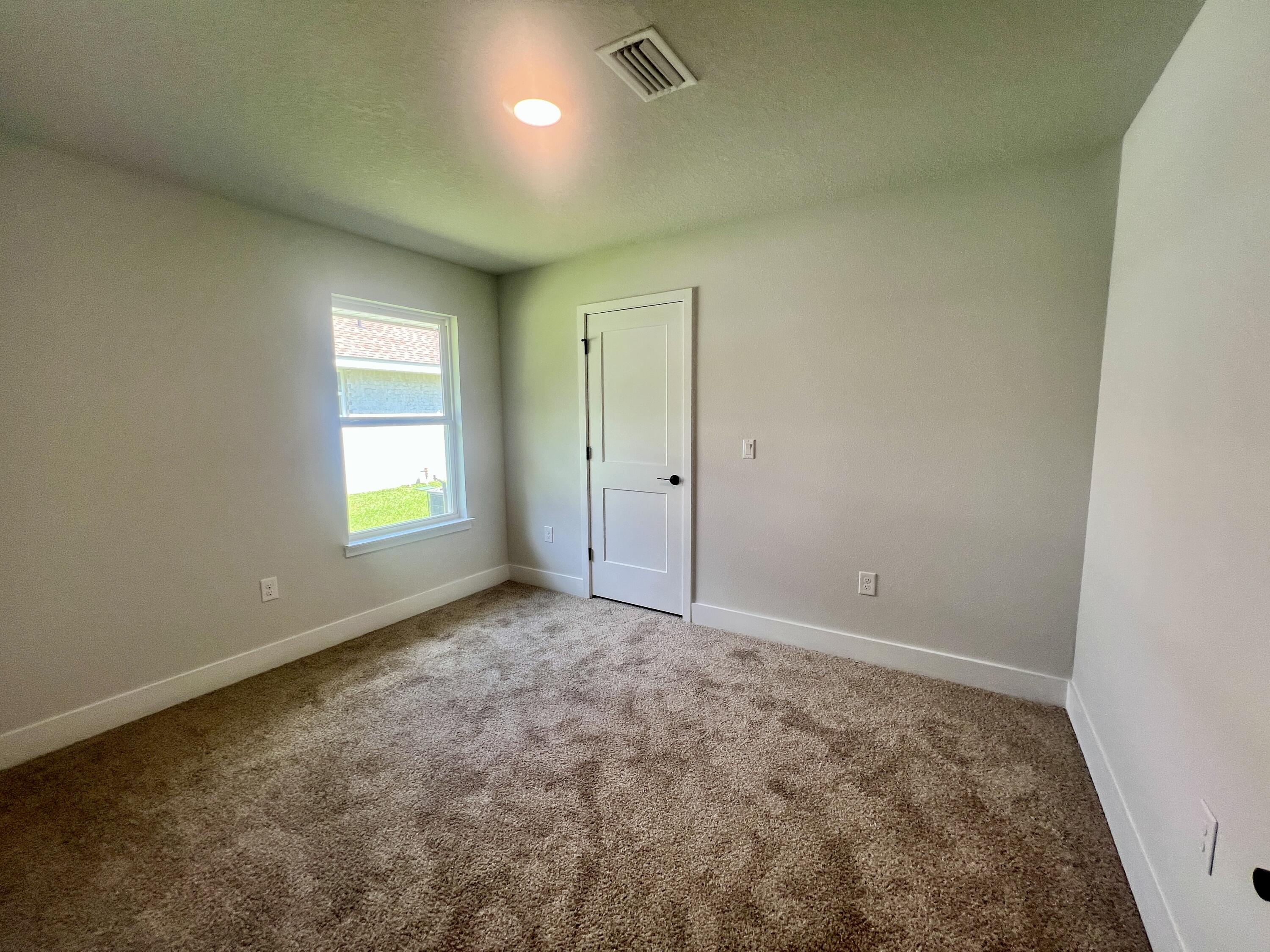 5283 Hidden Pines Circle Milton, FL 32583 - Photo 9 of 16 an empty room with windows