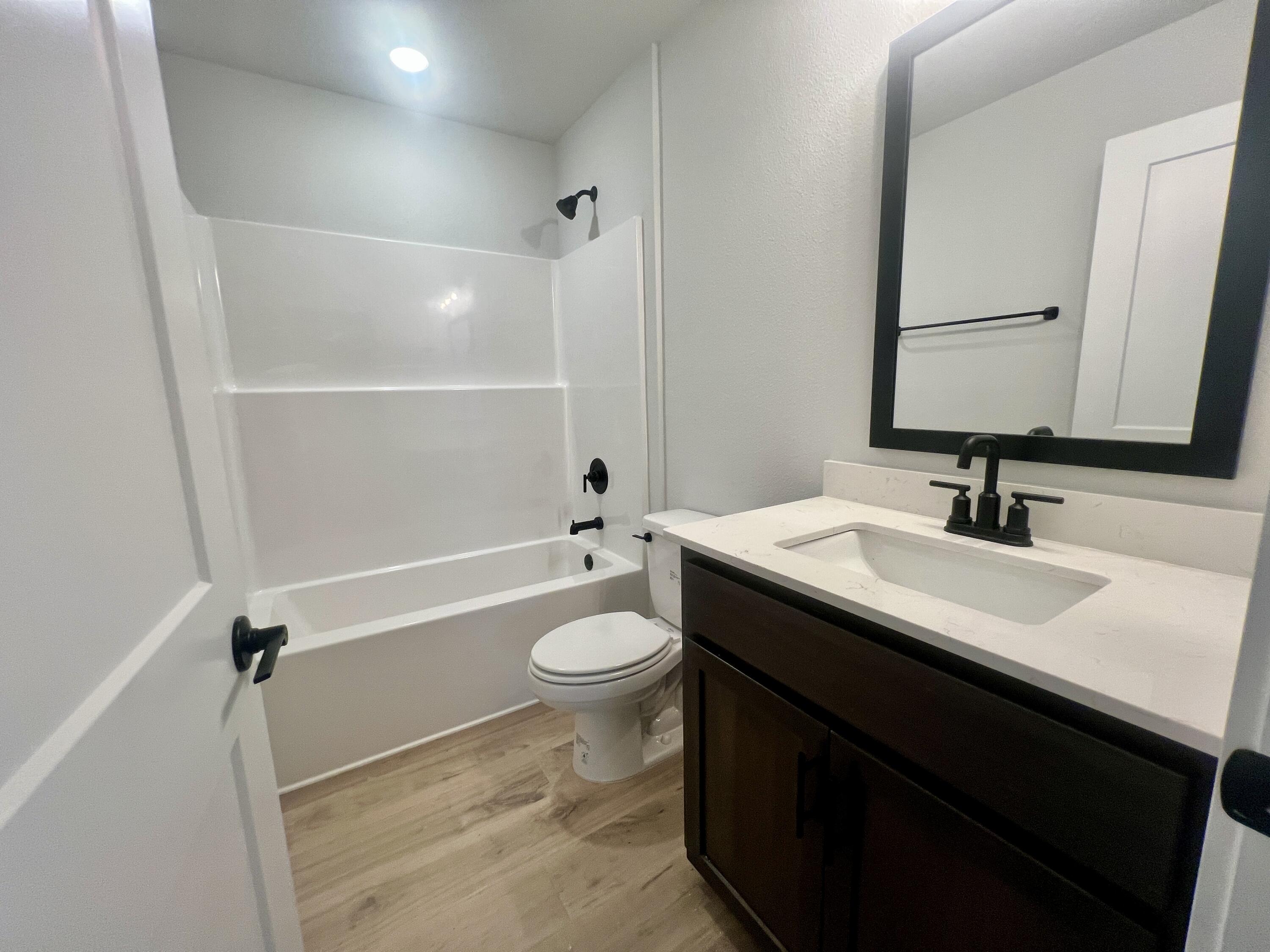 5283 Hidden Pines Circle Milton, FL 32583 - Photo 10 of 16 a bathroom with a sink a toilet and shower