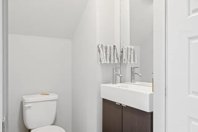 a bathroom with a sink a toilet and a mirror