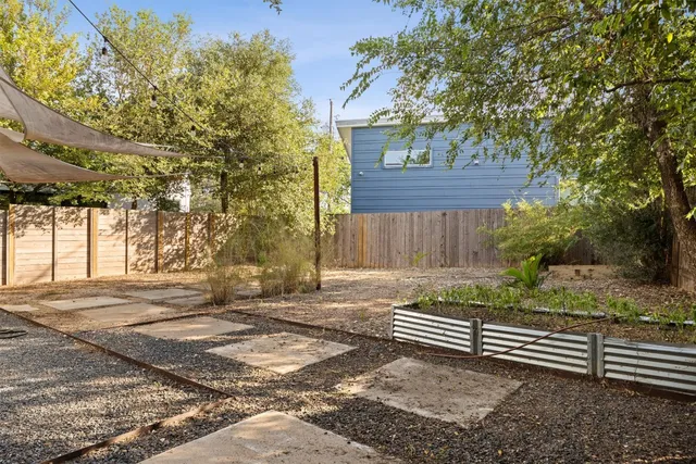 a view of a backyard with wooden fence