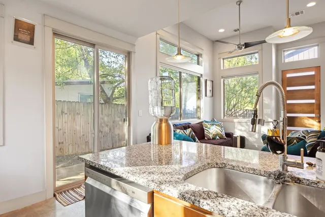 a kitchen with granite countertop a sink and a window