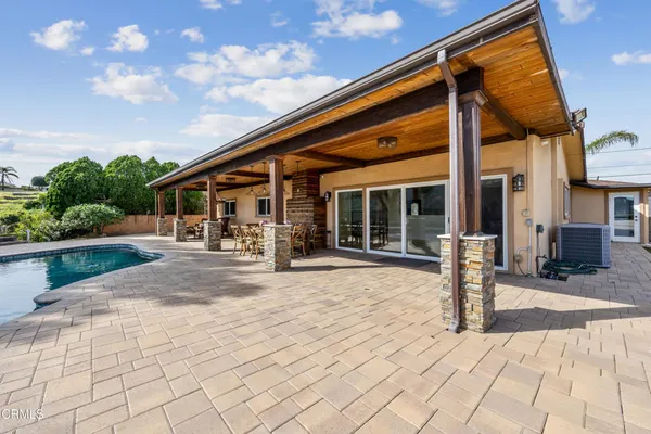 a swimming pool with outdoor seating and yard