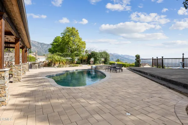 an aerial view of residential house with outdoor space and mountain view