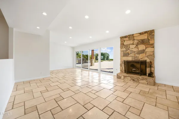 a view of an empty room and a fireplace
