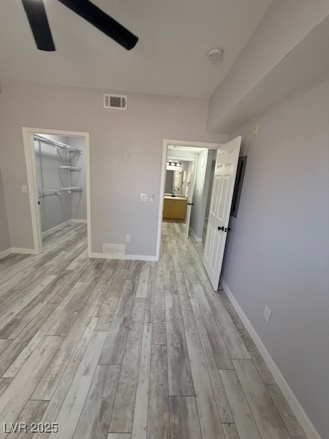 6955 North Durango Drive, Unit 1013 Las Vegas, NV 89149 - Photo 13 of 13 Unfurnished bedroom with a ceiling fan, a walk in closet, and a closet