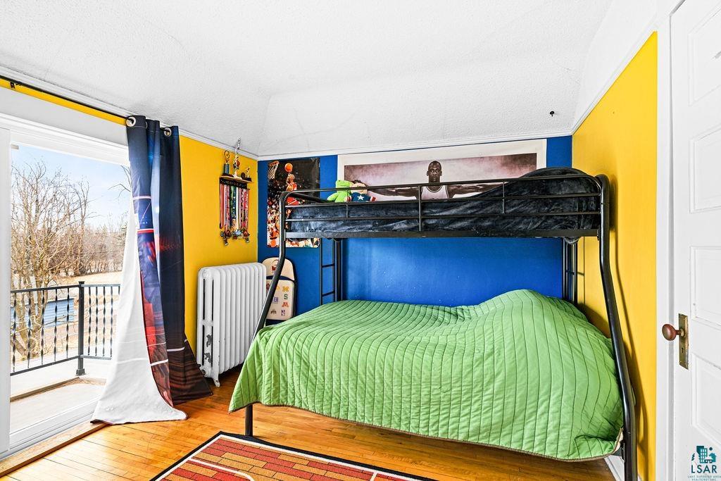 4608 Regent Street Duluth, MN 55804 - Photo 24 of 43 Bedroom with lofted ceiling, radiator, and hardwood / wood-style floors