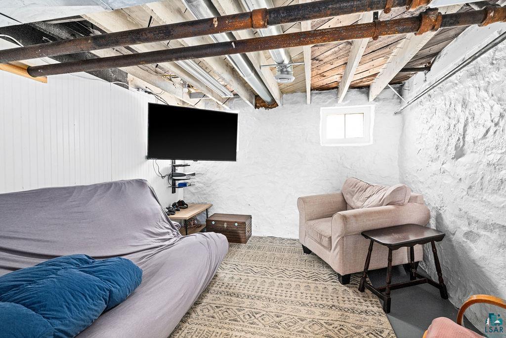 4608 Regent Street Duluth, MN 55804 - Photo 30 of 43 Living room with beam ceiling and a textured wall