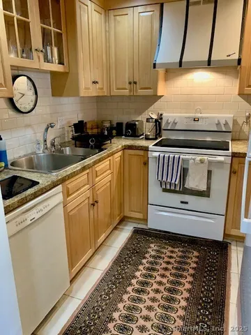 a kitchen with sink and cabinets