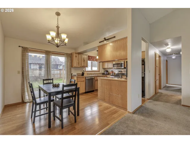 a view of a dining room with furniture and chandelier