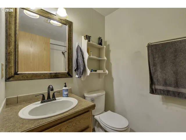 a bathroom with a sink a toilet and a mirror