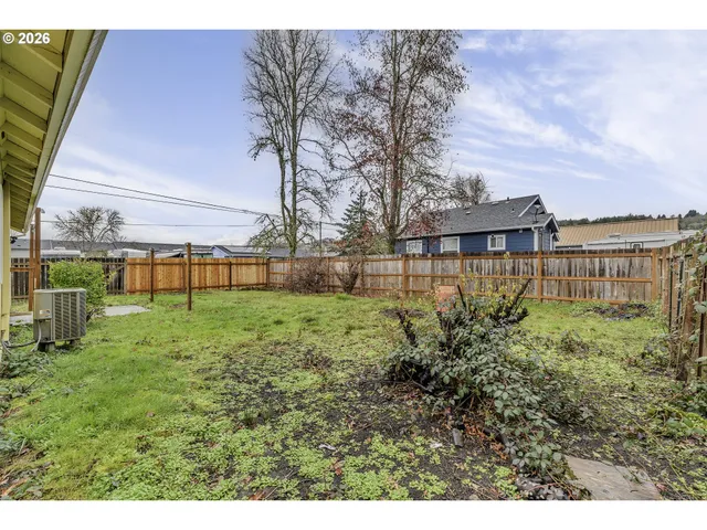 a view of backyard with swimming pool and seating