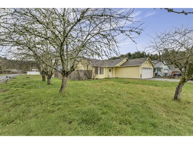a yellow house with trees in front of it