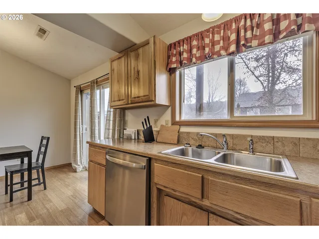 a kitchen with a sink cabinets and a window