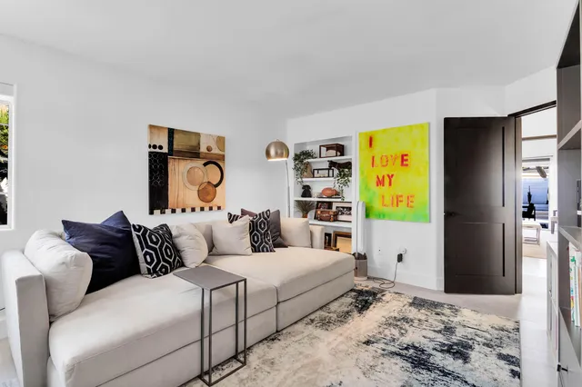 a bedroom with a bed and painting on the wall