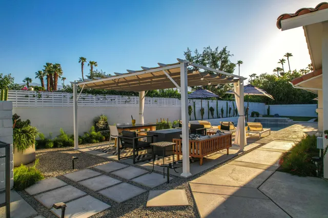 a view of a patio with table and chairs potted plants with wooden floor