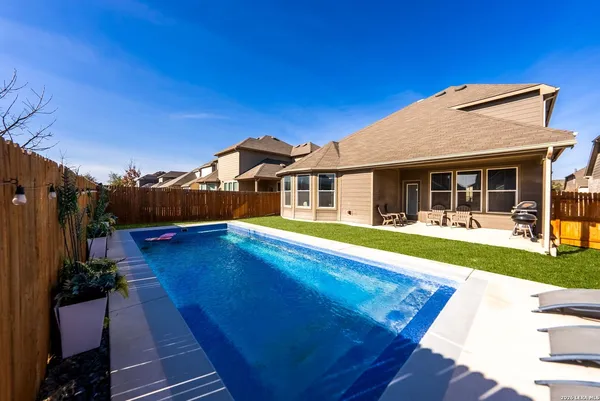 a view of a house with pool and wooden floor