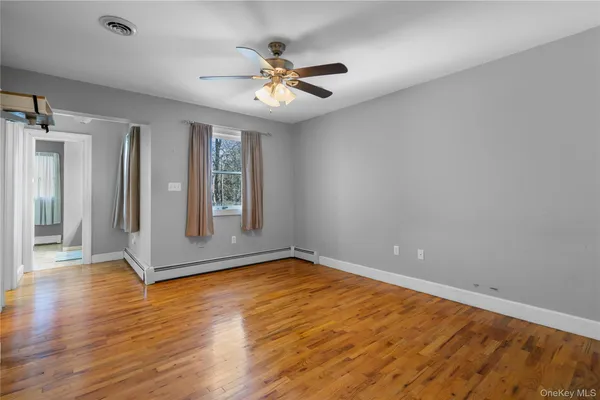 wooden floor in an empty room with a window