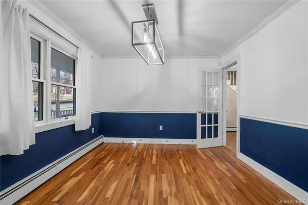 a view of a room with wooden floor and staircase