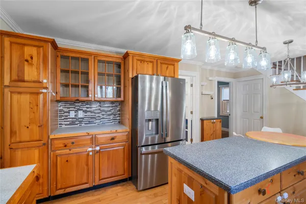 a kitchen with stainless steel appliances granite countertop a refrigerator a stove and a sink