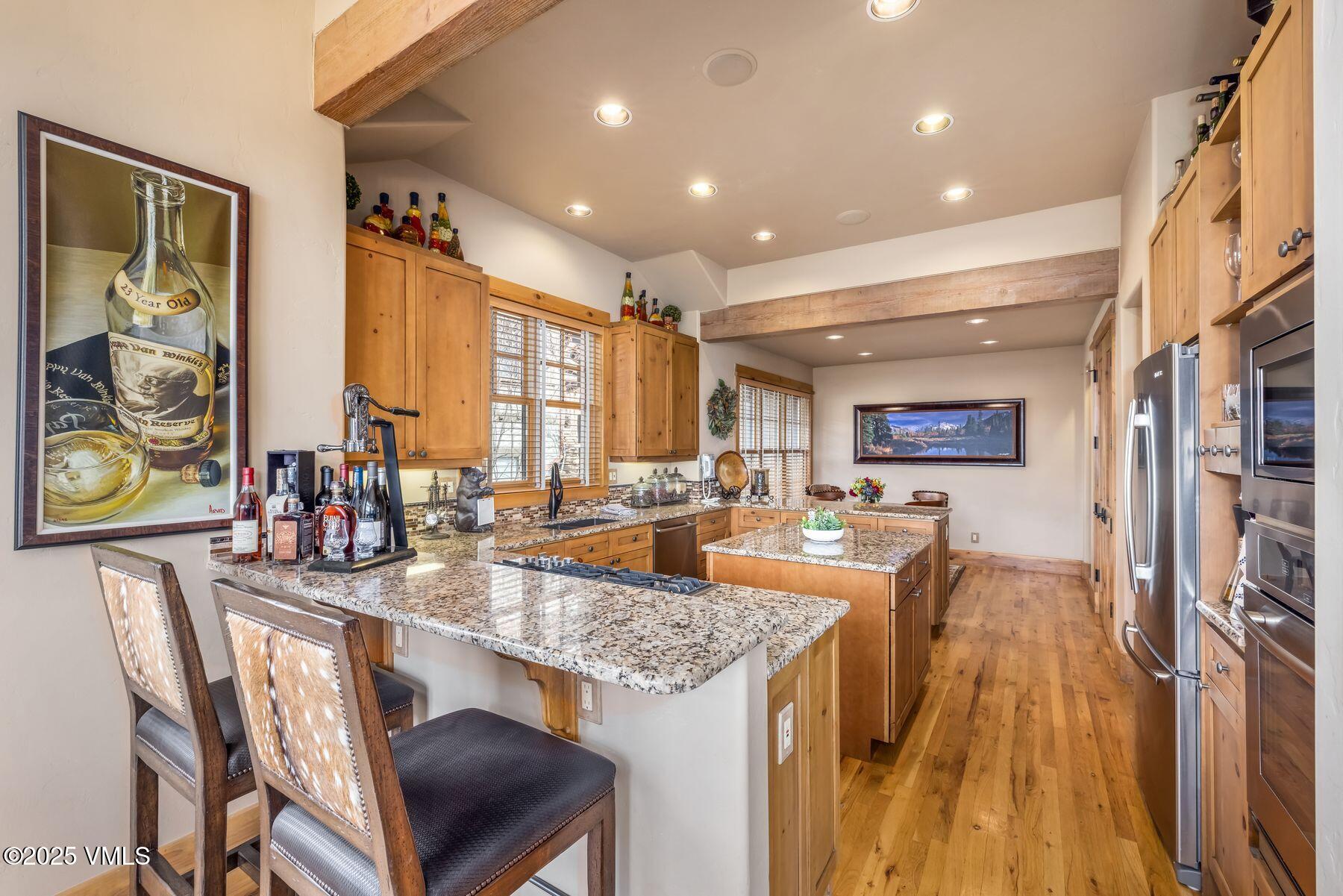 33 Legends Court Edwards, CO 81632 - Photo 21 of 50 a very nice looking dining room with a large window kitchen island and stainless steel appliances