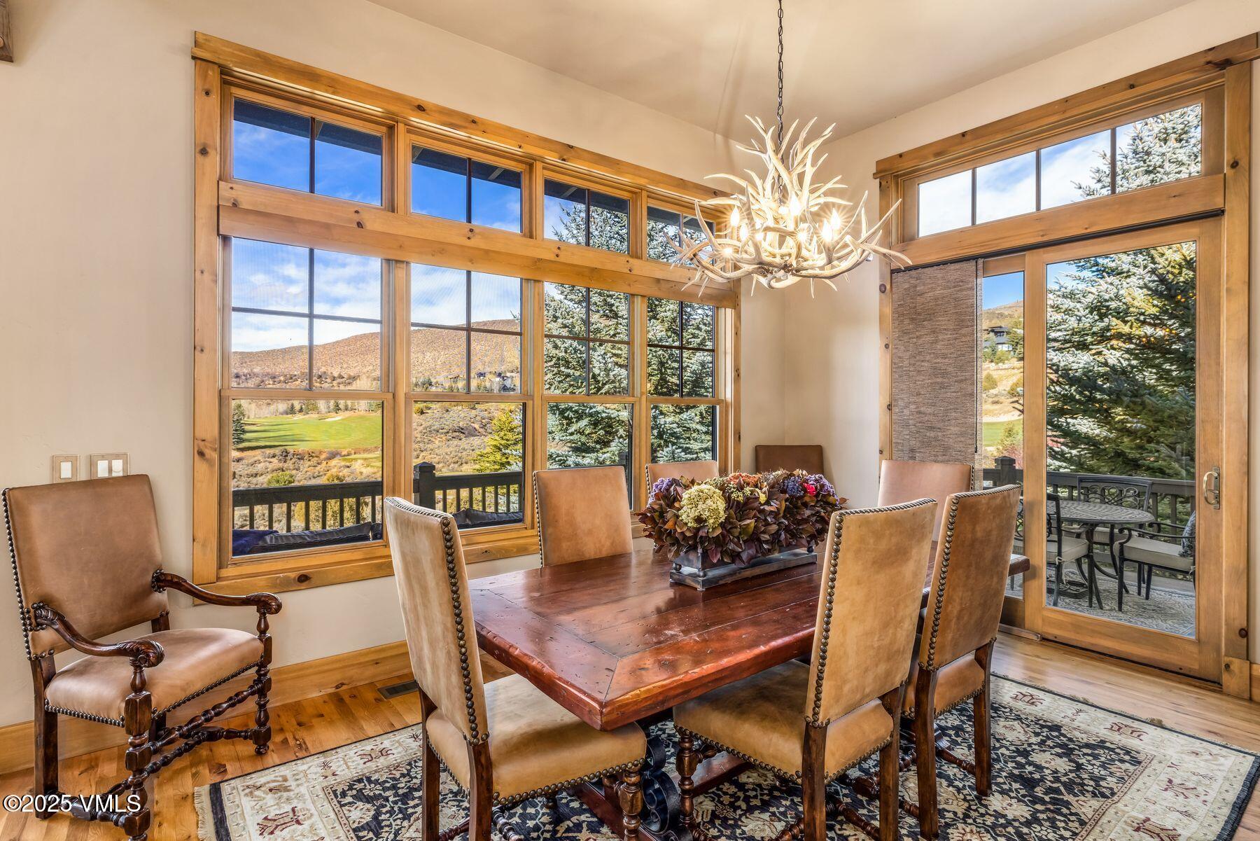 33 Legends Court Edwards, CO 81632 - Photo 24 of 50 a dining room with furniture a chandelier and wooden floor