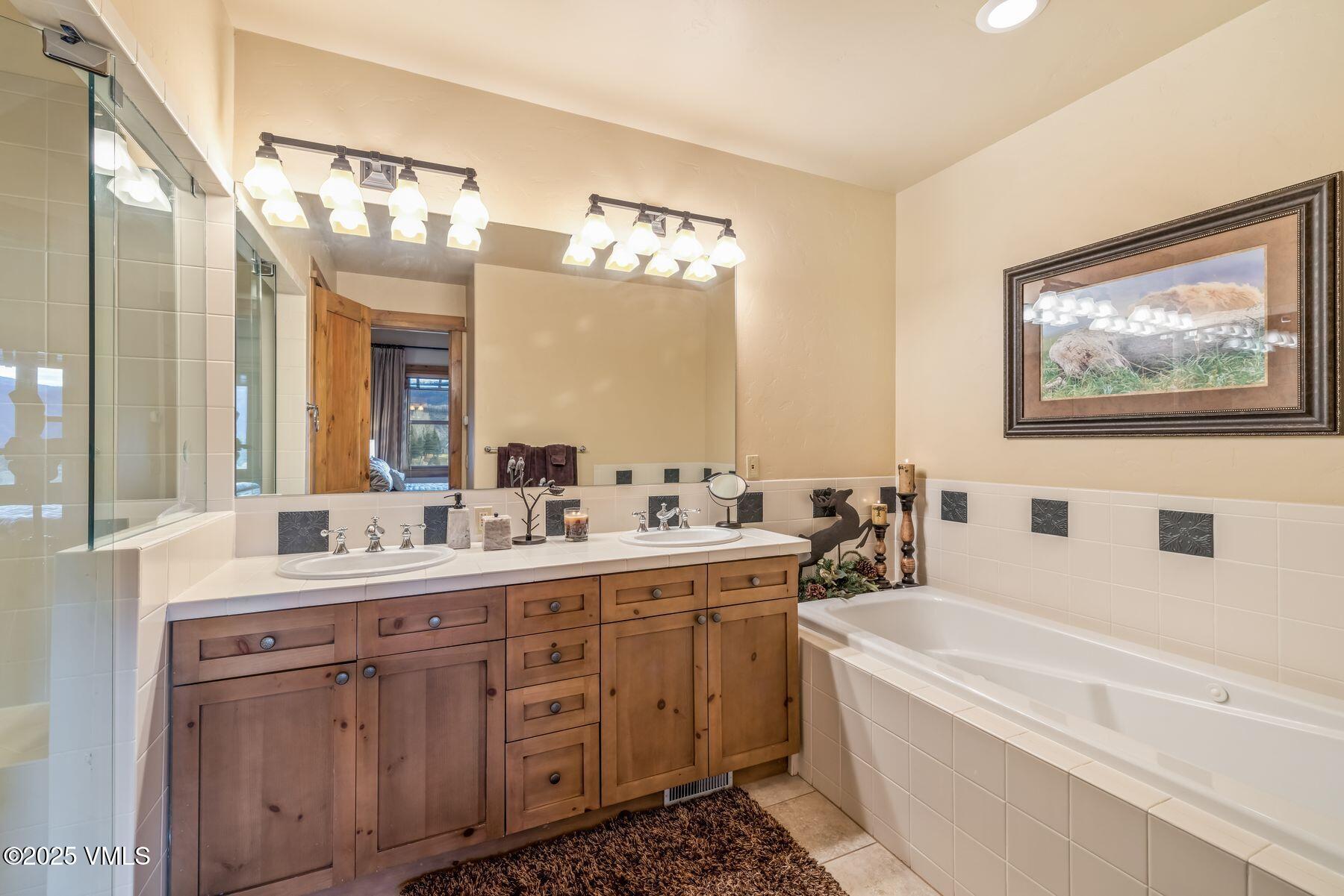 33 Legends Court Edwards, CO 81632 - Photo 33 of 50 a bathroom with a double vanity sink mirror and bathtub