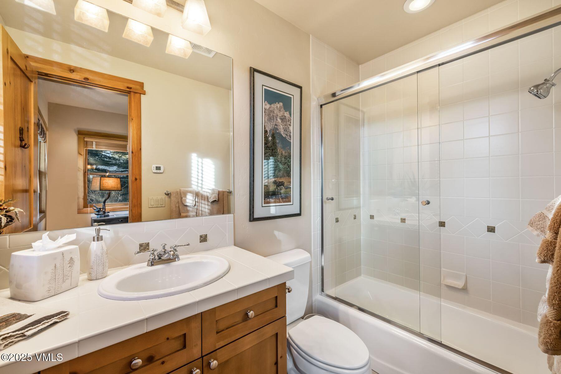 33 Legends Court Edwards, CO 81632 - Photo 37 of 50 a bathroom with a granite countertop sink toilet and shower