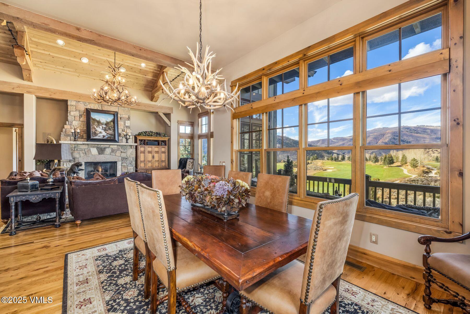 33 Legends Court Edwards, CO 81632 - Photo 6 of 50 a view of a dining room with furniture a chandelier and wooden floor