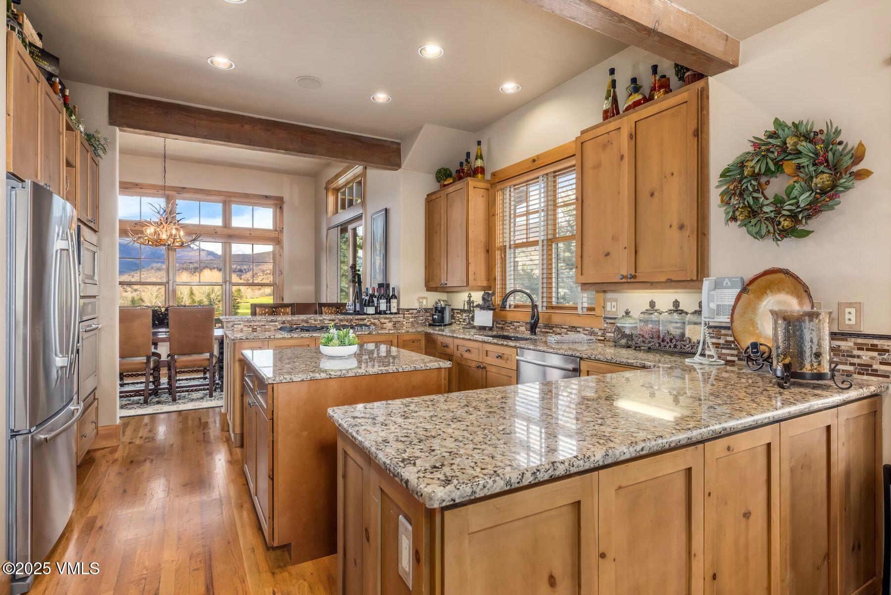 33 Legends Court Edwards, CO 81632 - Photo 7 of 50 a kitchen with stainless steel appliances granite countertop a sink a stove and a wooden floors
