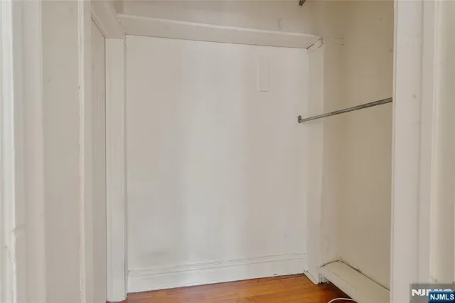 a hallway with a black white checkered floor and a table