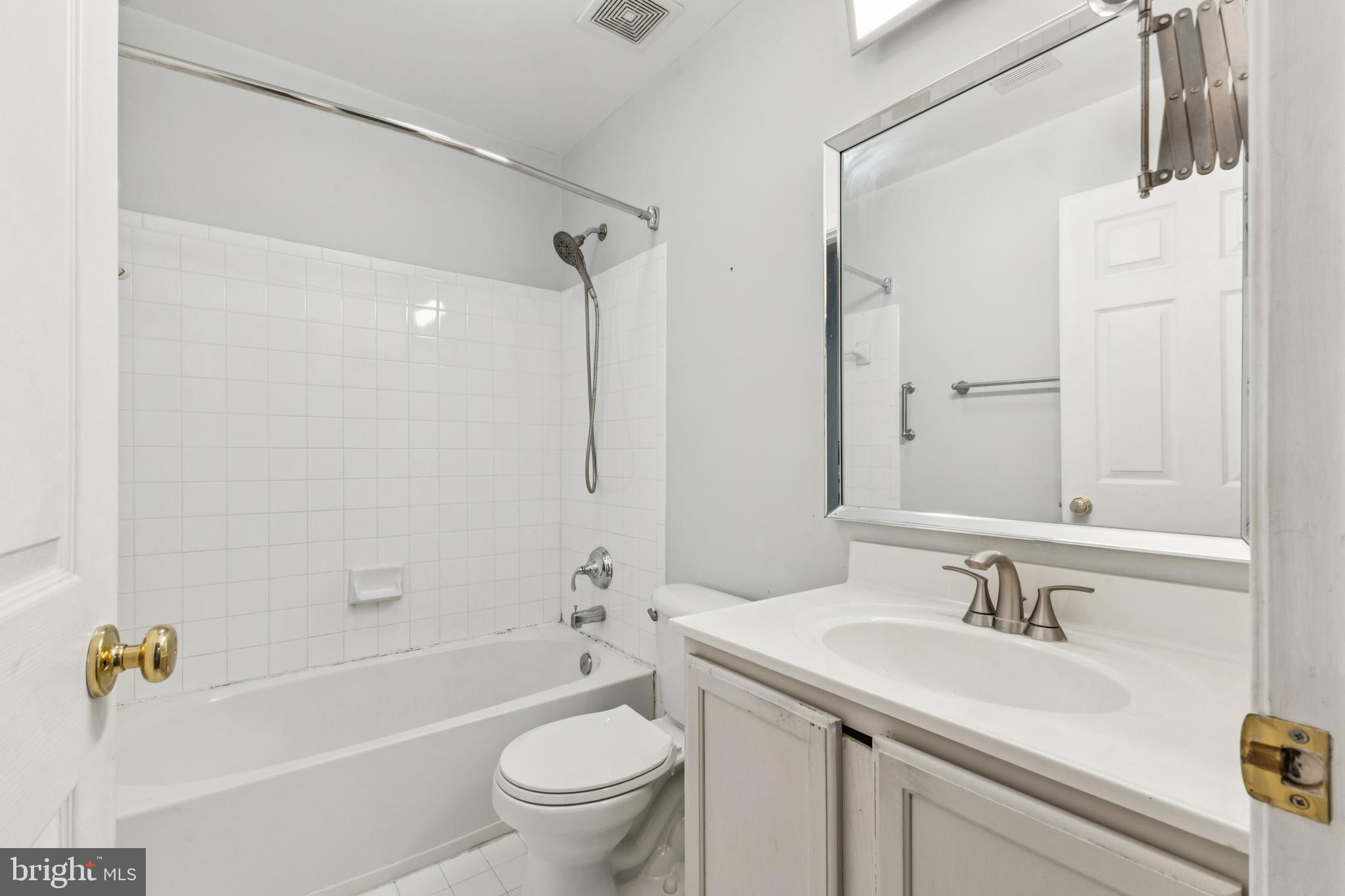 43067 Candlewick Square Leesburg, VA 20176 - Photo 16 of 25 a bathroom with a granite countertop sink a toilet and a bathtub
