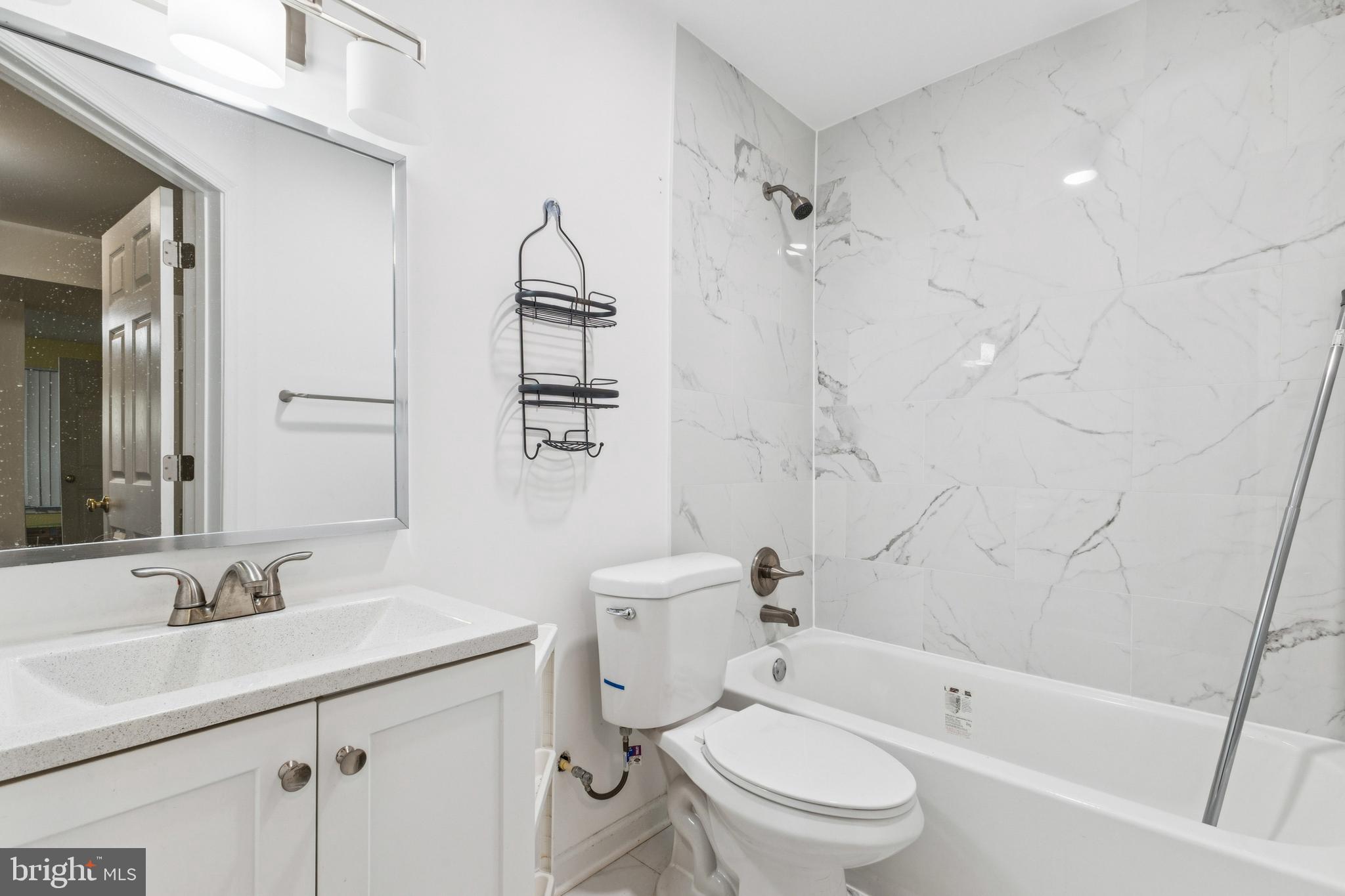 43067 Candlewick Square Leesburg, VA 20176 - Photo 24 of 25 a bathroom with a sink toilet and shower