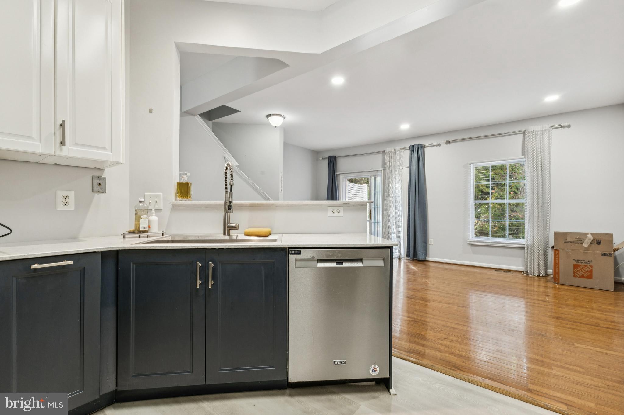 43067 Candlewick Square Leesburg, VA 20176 - Photo 10 of 25 a kitchen with stainless steel appliances granite countertop a sink and cabinets with wooden floor