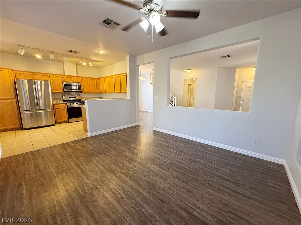 2185 Polynesia Circle Henderson, NV 89074 - Photo 37 of 37 An inviting open floorplan connects the living area with a well-appointed kitchen.